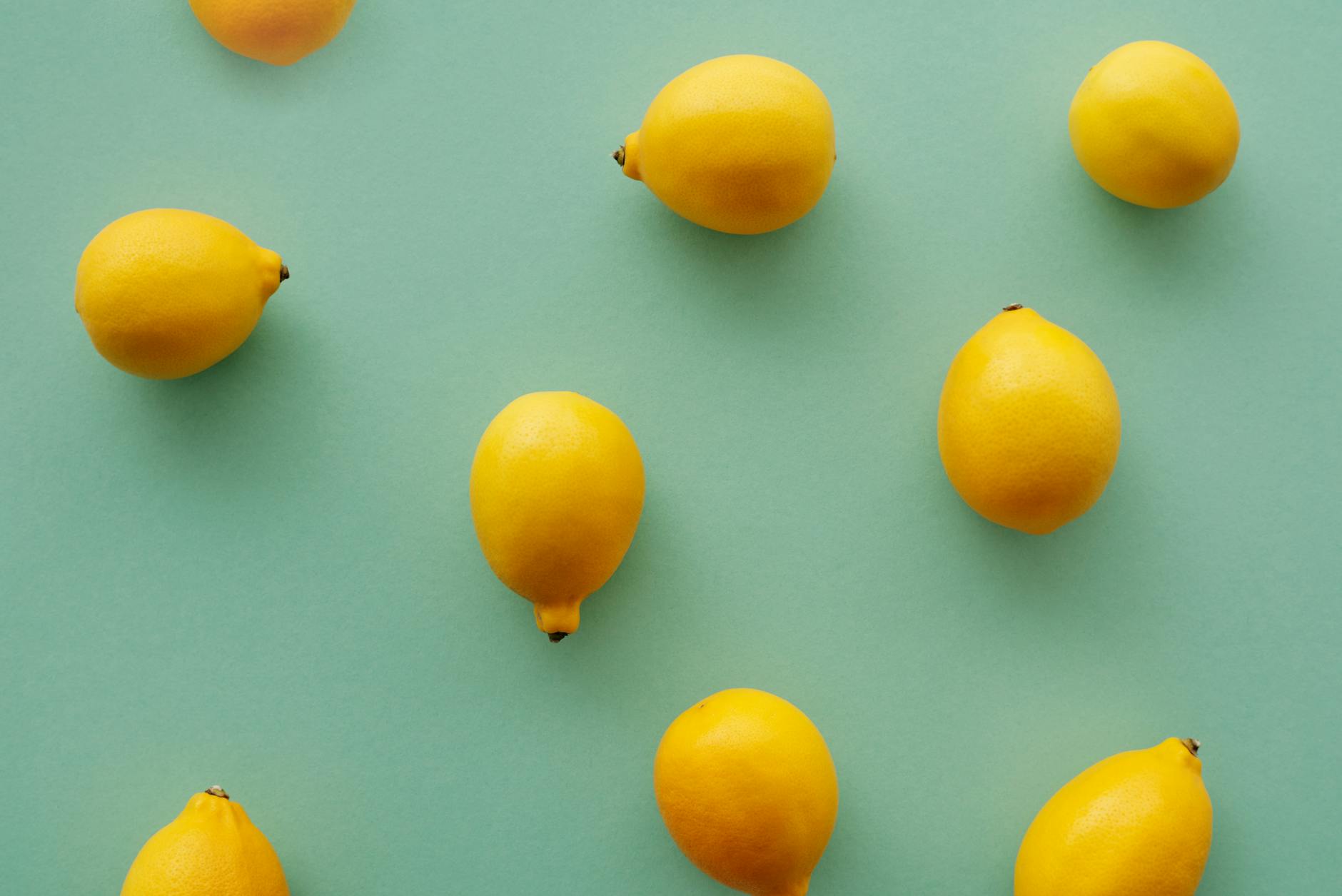 Bright yellow lemons on a fresh green background, symbolizing vibrant pleasure and renewal