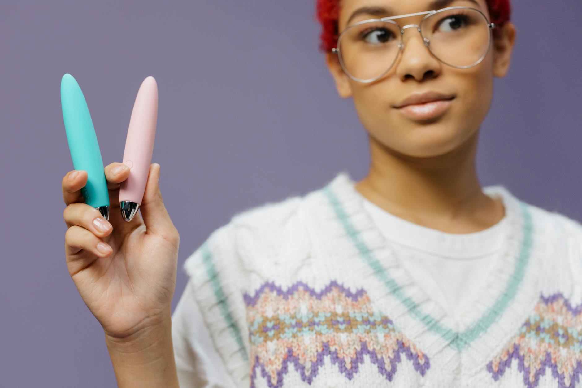 Person holding colorful vibrators, representing intimate wellness and reconnection tools