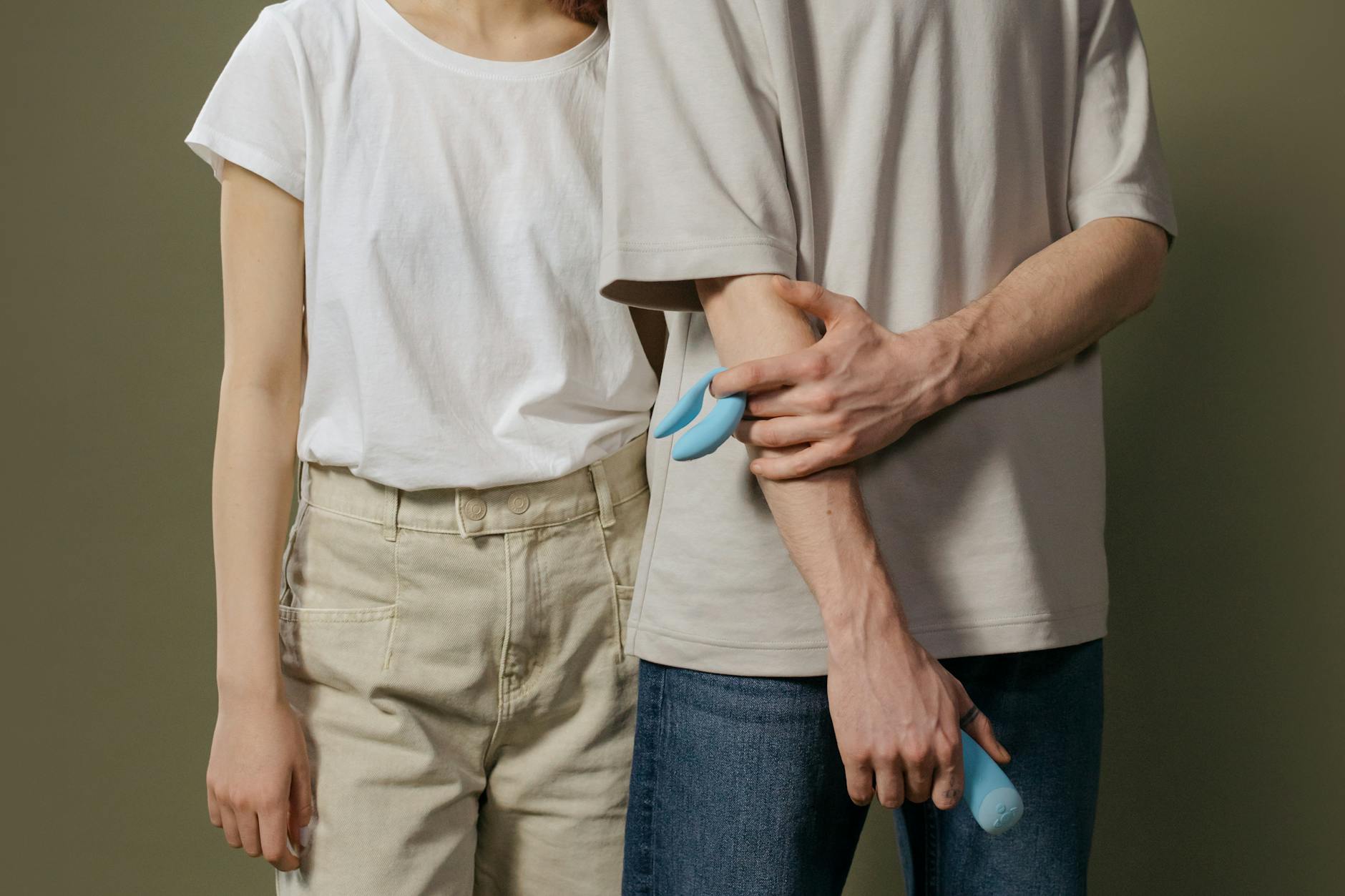 A blue silicone sex toy held in hand against a solid purple background, promoting self-love and sexuality.
