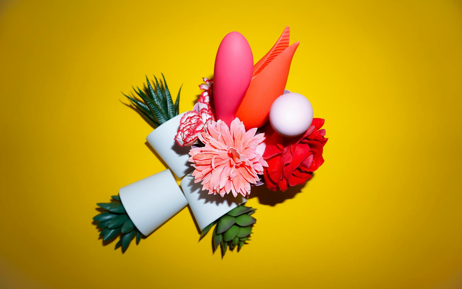 Woman holding colorful vibrators, representing reclaimed sensory control during intimacy.